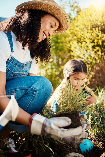 裏庭に一緒に植物を植える母親と娘を持つ家族 または園芸 春の庭で働く女性と女性の子供と自然 子供や造園 — ストック写真