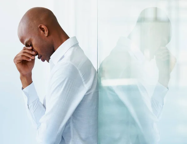 Stock image I dont know where it all went wrong. A distressed businessman holds his head in his hands