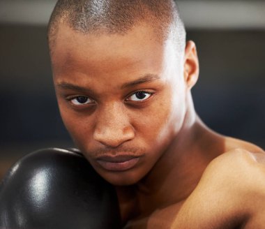 Resolved to succeed. A young boxer with determination and focus in his eyes clipart