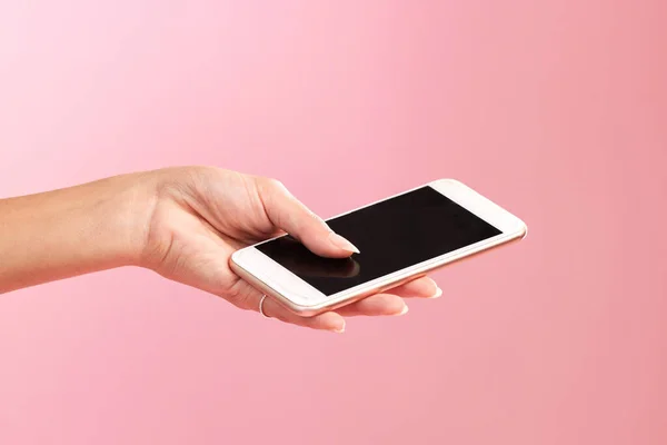 Phone mockup, hands and screen in studio isolated on a pink background. Cellphone, social media and woman with mobile smartphone for branding, advertising or marketing for product placement space