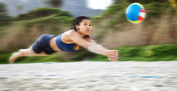 Beach volleyball, diving or sports girl playing a game in training or fitness workout in summer. Air jump, blurry dive action or active woman on sand in a fun competitive match in Sao Paulo, Brazil.