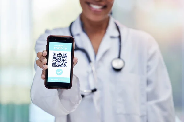 Doctor with QR code for healthcare or covid test results on contactless technology on mobile cellphone online. Hand, smartphone and woman medical or medicine professional with electric registration.