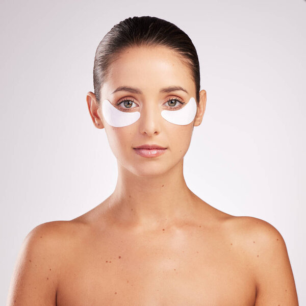 You wont find any wrinkles around here. an attractive young woman wearing an under eye patch against a studio background