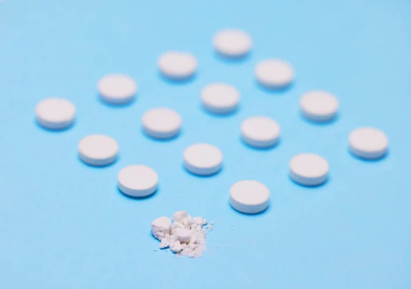 These pills are crushing it. Studio shot of pills against a blue background