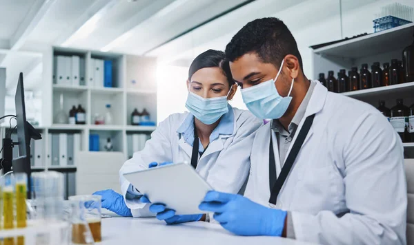 A lab is a room full of hope. two young researchers working in a laboratory