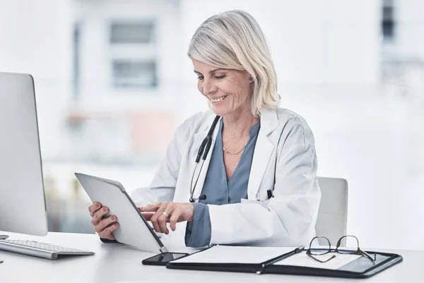 Medical news you can use. a mature doctor using a digital tablet at work