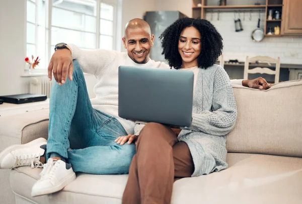 Happy couple, watch film online with laptop and streaming with network, smile and relax in living room. Subscription, internet connectivity and wifi with technology, people at home together on sofa.