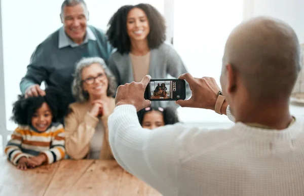 stock image Love, smile or phone photography with happy family in living room for social media, bonding or relaxing. Happiness, pictures or generations with grandparents or children at home for memory or support.