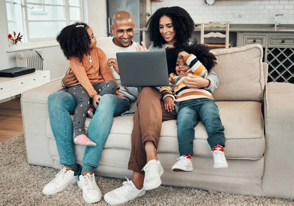 Happy family, laptop and kids on sofa for video, comedy movie and streaming on internet for quality time. Man, woman and children with computer for film, movies or games on lounge couch for holiday.
