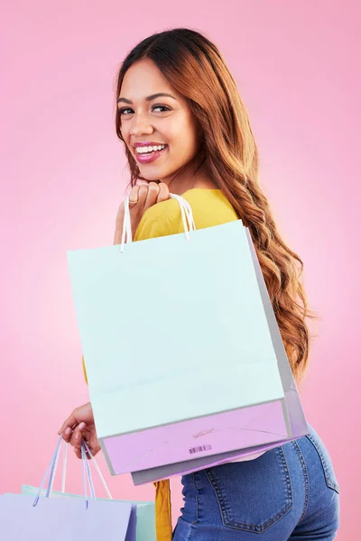 Stock image Portrait, shopping and smile with a black woman customer in studio on a pink background for retail. Face, fashion or sale and an attractive young female shopper happy with a deal or promotion.