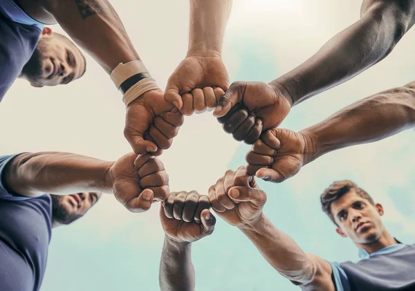 stock image Hands, fist and solidarity with a sports team standing in a huddle for unity or motivation before a game. Fitness, teamwork and diversity with a group of men in a circle, getting ready for a match.