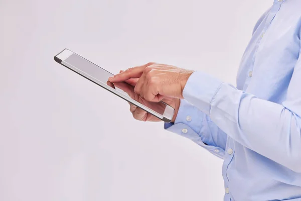 stock image Hands, tablet and business man typing in studio isolated on a white background. Technology, social media and male professional with touch screen for research, web scrolling and internet browsing