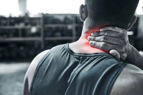 Neck pain can stop any bodybuilder. Back of an athlete with neck pain. A neck injury is serious. Bodybuilding risks CGI red spots of pain. Hand of an active man touching his neck in pain.