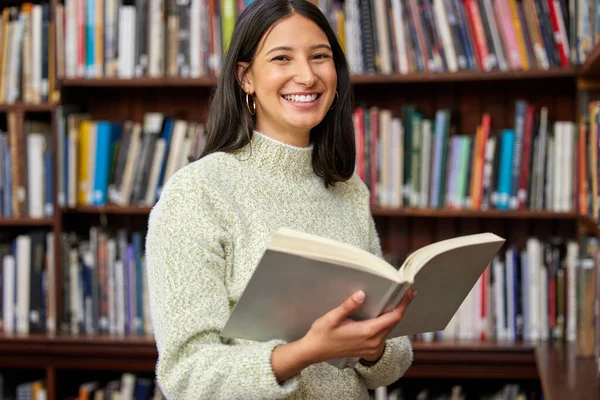 Success has already been written. a young woman reading a book in a library