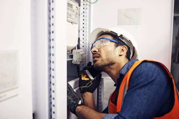 Man, phone call and engineering in control room, switchboard or industrial system inspection. Male electrician talking on smartphone at power box, server mechanic or electrical substation maintenance.