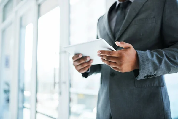 Stock image One device that does it all. a businessman using a digital tablet in a modern office