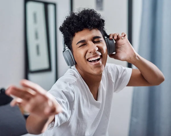 stock image Music got me through quarantine like...a young man using headphones to listen to music at home