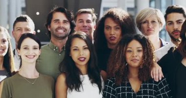 Group face portrait of happy formal corporate business people standing proud together in their workspace. A crowd of proud, professional and diverse employee team smiling looking at the camera.