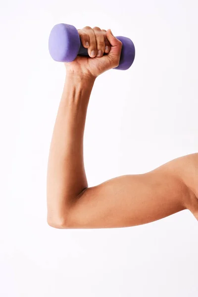 Stock image These are very handy. Studio shot of a muscular woman working out using dumbbells