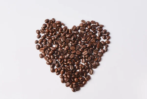For the love of coffee. Studio shot of coffee beans shaped in a heart against a white background