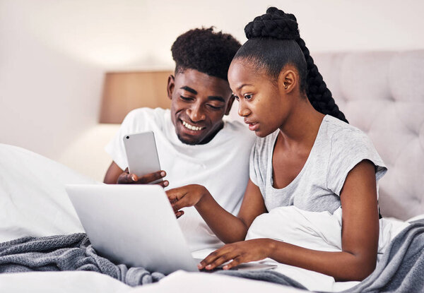 I thinK I found the post you were looking for. a young couple using wireless devices while sitting on their bed together