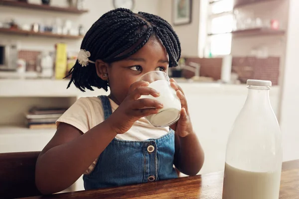 stock image Theres no such thing as too much milk. an adorable little girl drinking a glass of milk at home