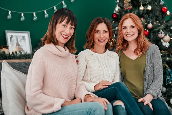 stock image We still believe in Santa. Portrait of three attractive women sitting on the sofa at Christmas time together at home