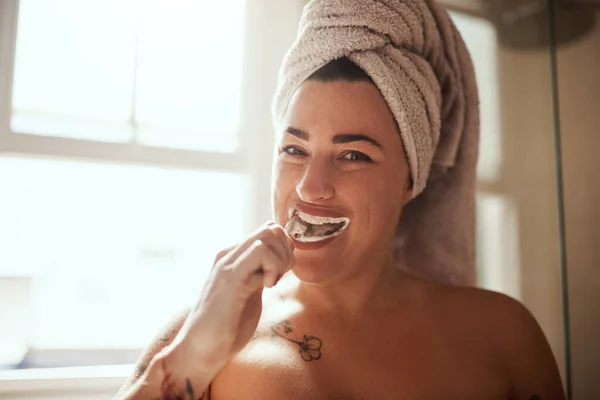 これは 明るい笑顔の美しい笑顔です 自宅の浴室で歯を磨く魅力的な若い女性が — ストック写真