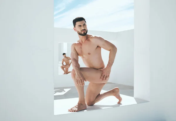 Man model, naked statue and art deco frame of a male posing outdoor for fine and lgbt artwork. Architecture, nude and live greek statues with a person with power and homosexual figure for creativity.