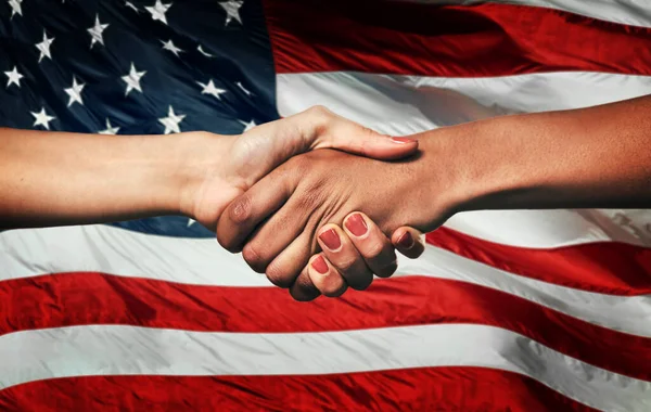 stock image Handshake, partnership and people with flag in USA for political agreement, cooperation and alliance. Election, support and American women shaking hands for democracy, collaboration and negotiation.