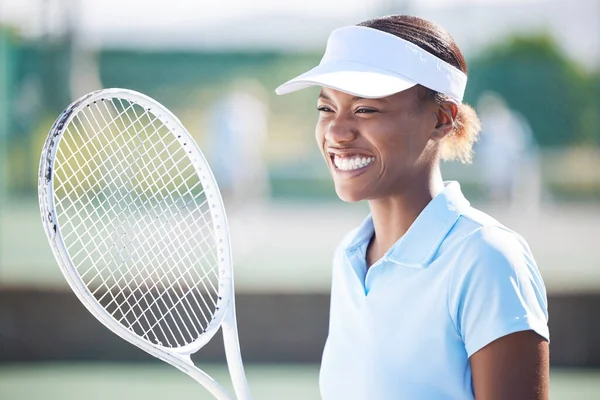Winner, tennis and smile of black woman on court after winning match, game or competition. Thinking, success and happy, proud or excited female athlete with sports target, workout or exercise goals