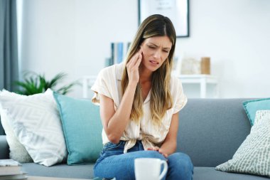 I should probably take something for it. an attractive woman experiencing a toothache clipart