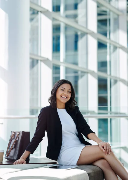 stock image Im ready to knock on success door. Cropped portrait of an attractive young businesswoman smiling while sitting in a waiting room