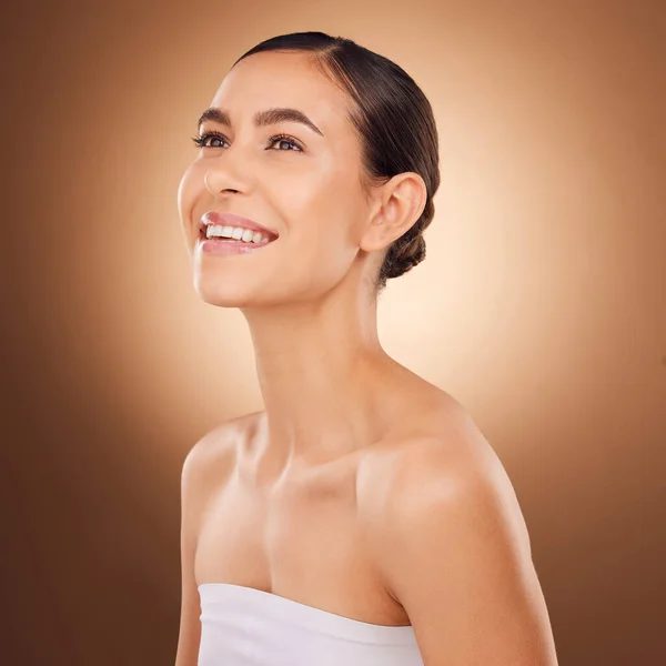 Studio face, happy and beauty woman with luxury facial cosmetics, natural makeup and skincare glow. Dermatology healthcare satisfaction, spa salon person or aesthetic female model on brown background.