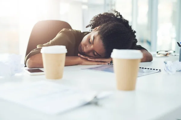 stock image Dreaming of success doesnt guarantee it, only hard work does. a young businesswoman sleeping with her head down on her office desk