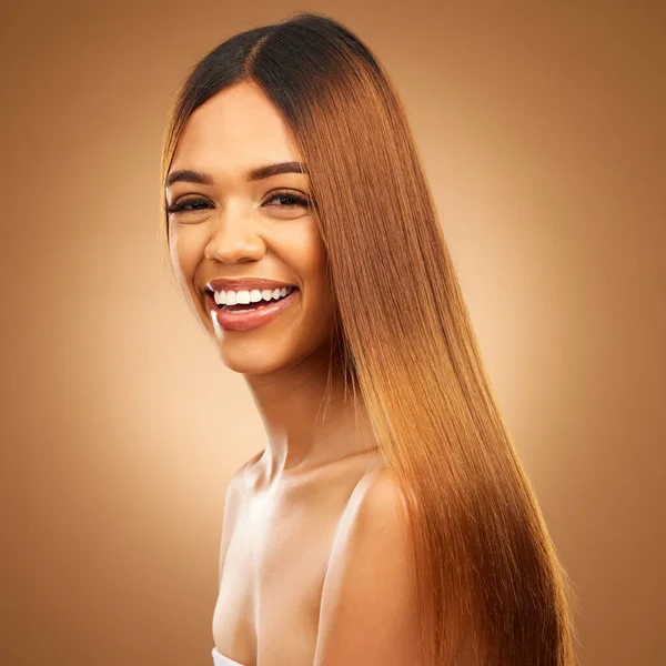 Portrait, beauty and hair care of woman in studio for growth and color shine or healthy texture. Aesthetic female happy face for haircare, natural makeup and hairdresser or salon on brown background.