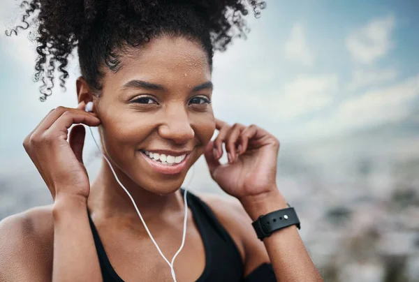 stock image Im so ready to rock this workout. Portrait of a sporty young woman listening to music while exercising outdoors