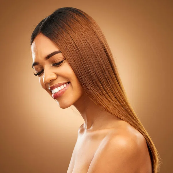 Smile, beauty and hair care of woman in studio for growth, color shine or healthy texture. Aesthetic female happy for haircare, natural skincare and hairdresser or salon mockup on brown background.