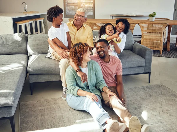 Happy family, love and relax in living room with generations, support and trust, grandparents with parents and children. Together, unity and people at home with bonding, smile and happiness with care.