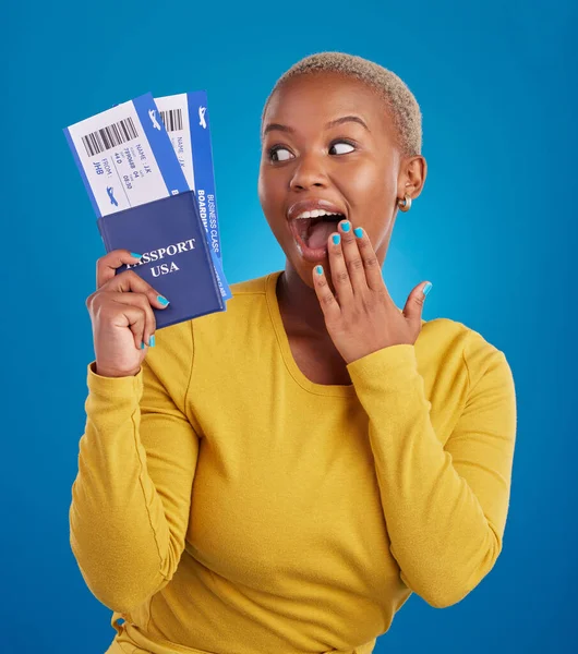Surprise, travel passport and black woman in studio on blue background with flight documents, tickets and ID. Traveling mockup, happy and girl celebrate immigration, USA holiday and global vacation.