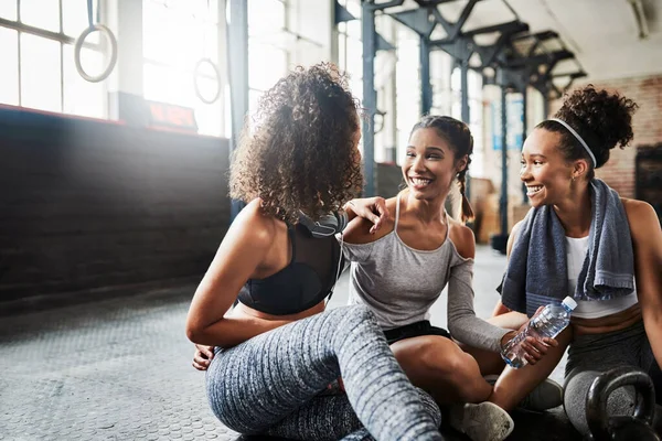 Those post workout chat sessions. a group of happy young women taking a break together at the gym