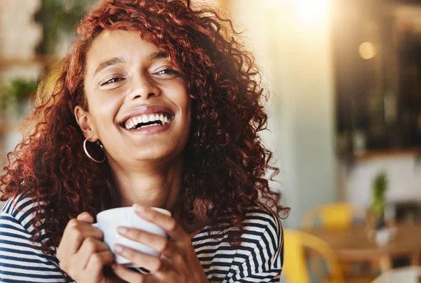 stock image Life begins after coffee. an attractive young woman enjoying a cup of coffee in a cafe