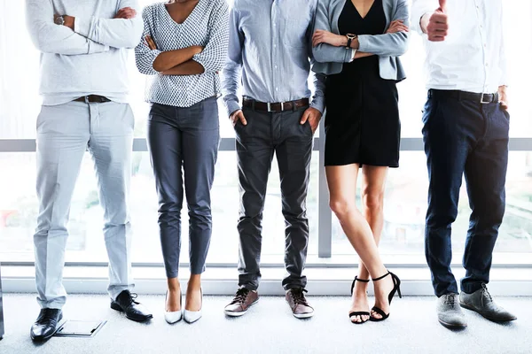 stock image Theyve got what it takes. a group of unrecognizable businesspeople standing in line in an office