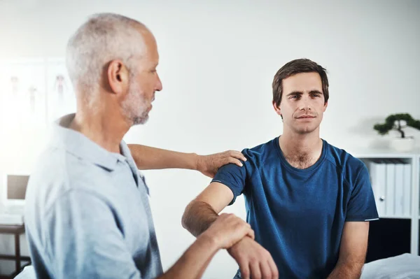 stock image Getting a thorough checkup. a physiotherapist treating a patient