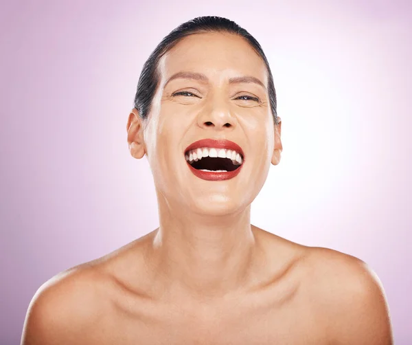 Laughing, face makeup and lipstick of woman in studio isolated on a purple background. Skincare, cosmetics portrait and happy, funny and mature female model with red lip gloss for skin glow or beauty.