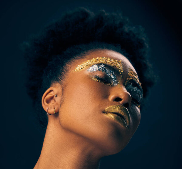 Beauty, gold and fantasy with black woman and makeup in studio for luxury, cosmetics and African pride. Natural, creative and goddess with female model on background for queen, bronze and glamour.