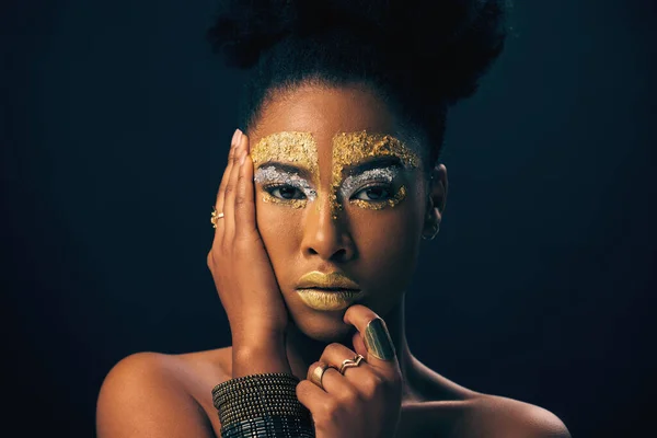 Makeup, gold and fantasy with portrait of black woman in studio for luxury, cosmetics or African pride. Natural, creative and goddess with female model on background for queen, bronze or glamour art.