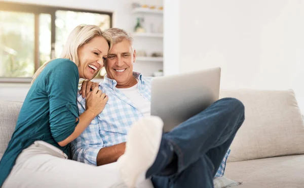Watching Favourite Sitcom Affectionate Mature Couple Using Laptop While Sitting — Stock Photo, Image