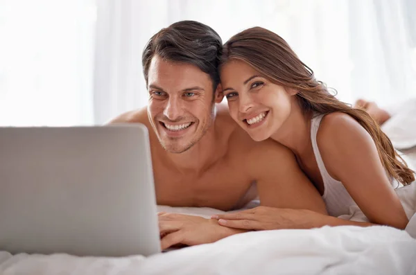 Love portrait, laptop and bedroom couple relax for morning peace, calm and streaming online Valentines Day movie. Smile, vacation holiday and romantic people bonding on hotel bed in Toronto Canada.
