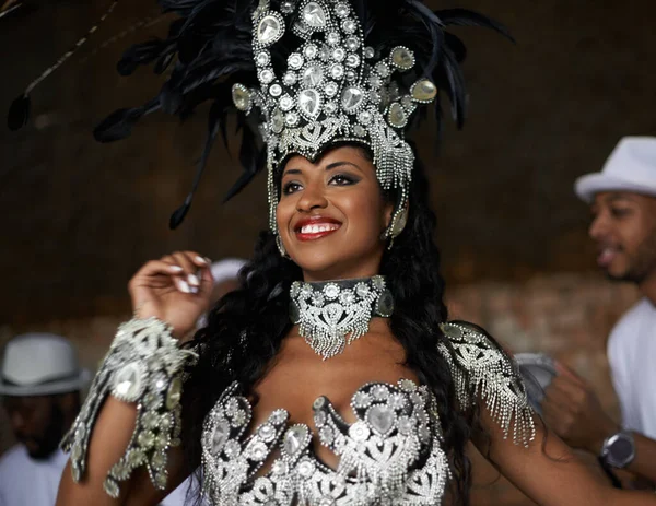 Shes a glamourous dancing queen. a beautiful samba dancer performing in a carnival with her band